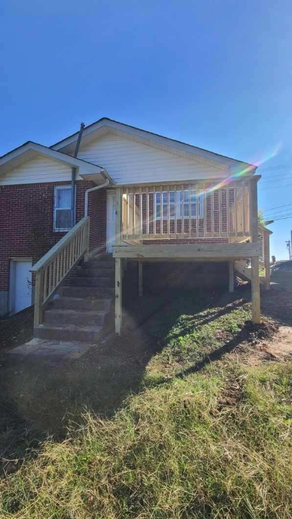 407 College Ave E, Carthage, TN 37030 - rear view of property featuring brick siding and a wooden deck