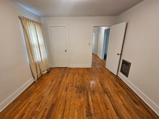 unfurnished bedroom with dark wood-type flooring