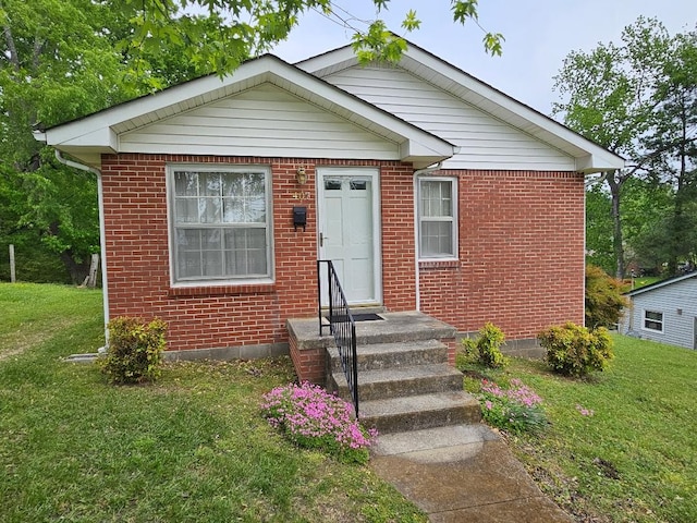 bungalow-style home with a front yard