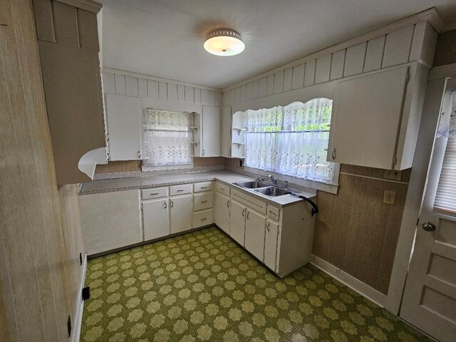 407 College Ave E, Carthage, TN 37030 - kitchen featuring tile patterned floors, light countertops, white cabinetry, and wooden walls