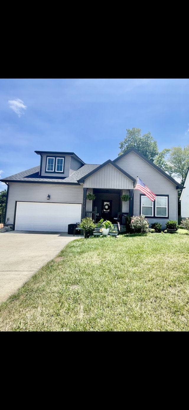 view of front of house with a front yard and a garage