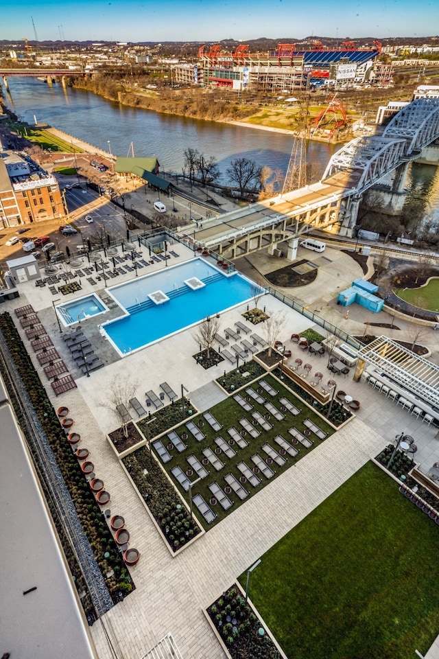 view of swimming pool featuring a water view and a patio area