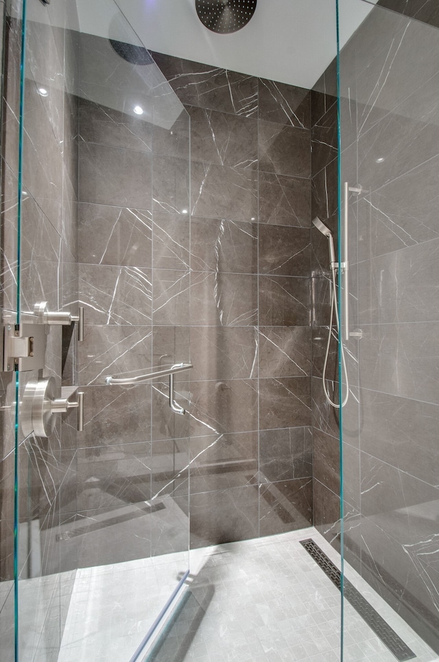 bathroom featuring a shower with shower door