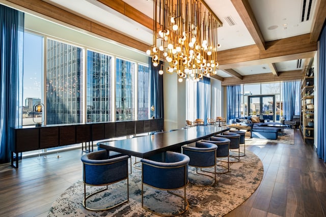 dining space featuring beamed ceiling, a chandelier, and dark hardwood / wood-style flooring