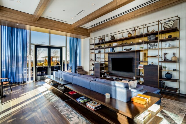 living room featuring hardwood / wood-style flooring and beamed ceiling