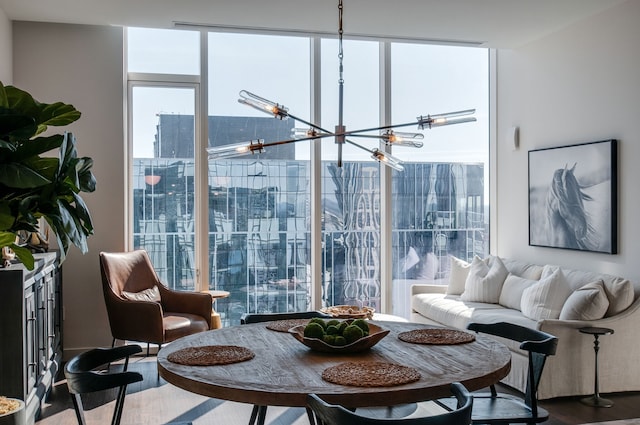 dining area with hardwood / wood-style floors and a notable chandelier