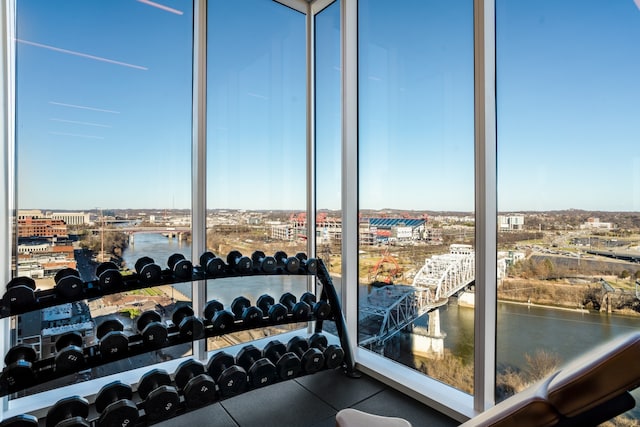 exercise room featuring a water view