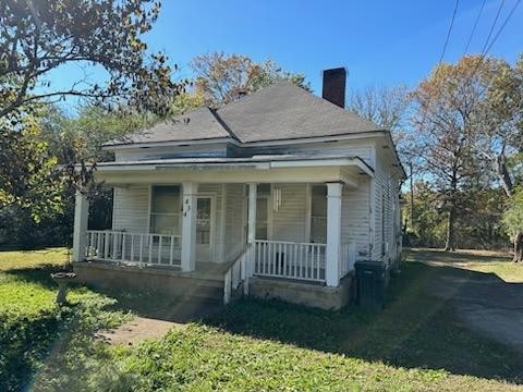 bungalow-style house featuring a porch and a front lawn