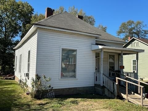 exterior space with a deck and a lawn