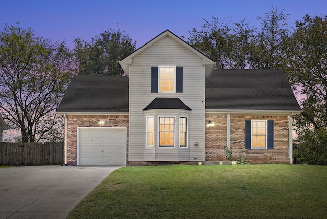 front of property featuring a yard and a garage