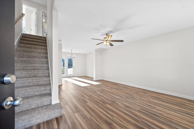 interior space with hardwood / wood-style floors and ceiling fan with notable chandelier