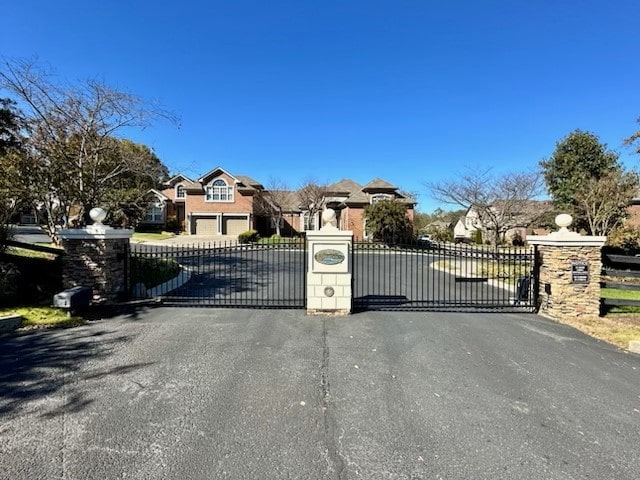 view of gate with a garage