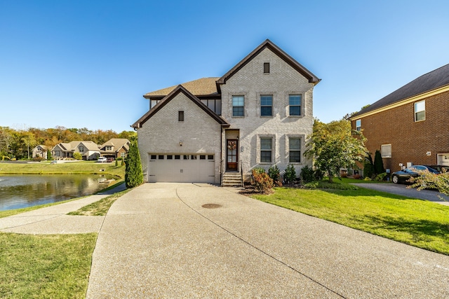 view of front facade with a water view and a front lawn