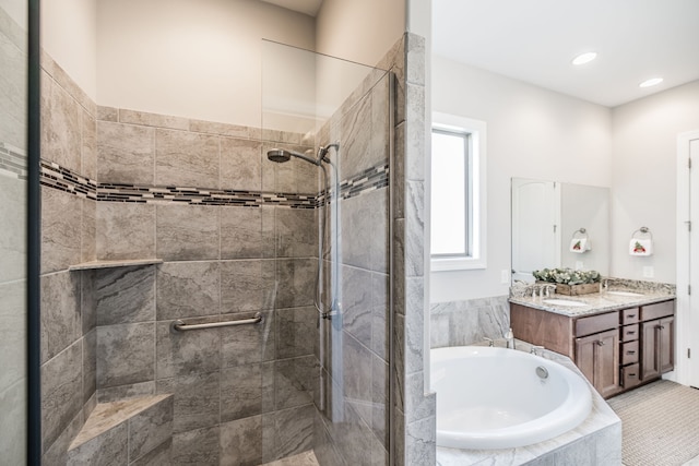 bathroom featuring tile patterned flooring, vanity, and shower with separate bathtub