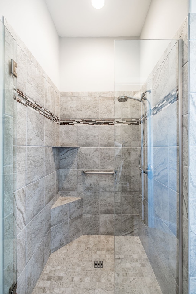 bathroom with a shower with shower door