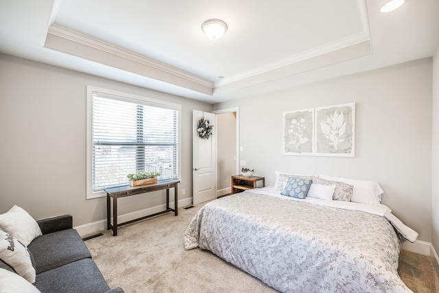 carpeted bedroom featuring a raised ceiling and crown molding