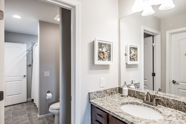 bathroom featuring tile patterned floors, vanity, and toilet