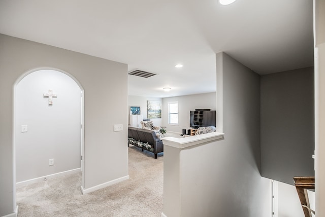 foyer featuring light colored carpet