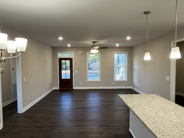 interior space with dark hardwood / wood-style floors and ceiling fan with notable chandelier