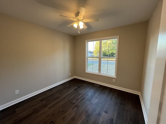 unfurnished room featuring ceiling fan and dark hardwood / wood-style floors