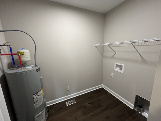 laundry area featuring washer hookup, dark wood-type flooring, and water heater