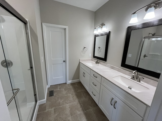 bathroom with vanity and a shower with shower door