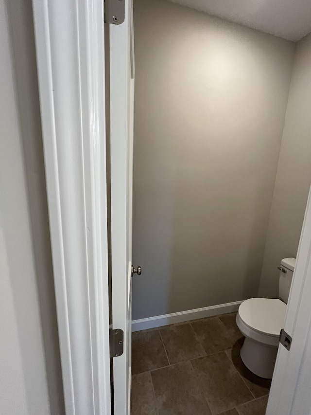 bathroom with tile patterned floors and toilet