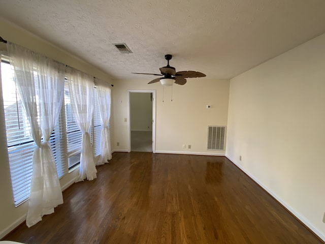 spare room featuring a textured ceiling, dark hardwood / wood-style flooring, and ceiling fan