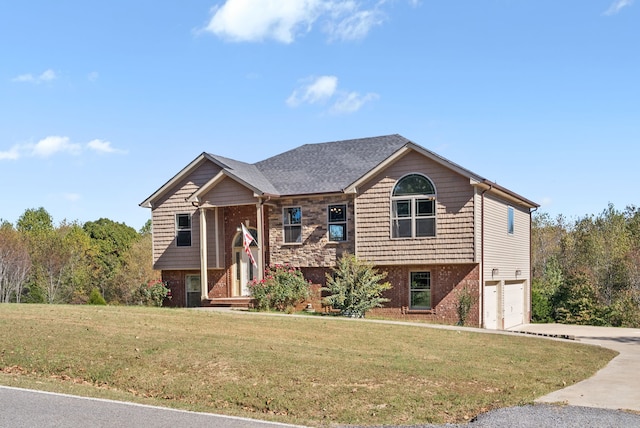 split foyer home featuring a garage and a front lawn