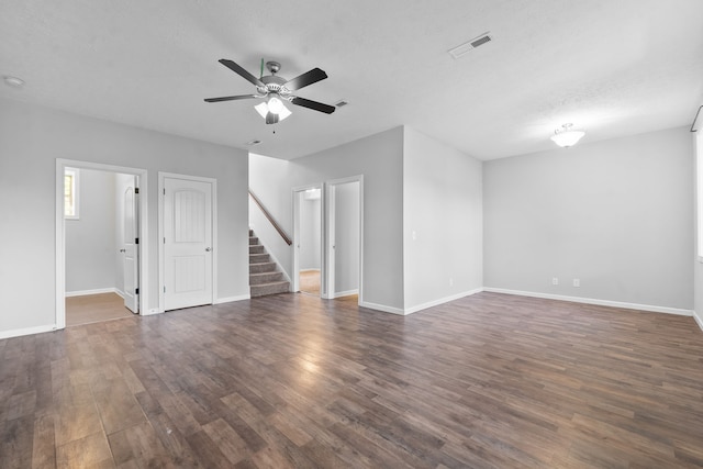 unfurnished living room featuring ceiling fan, a textured ceiling, and dark hardwood / wood-style flooring