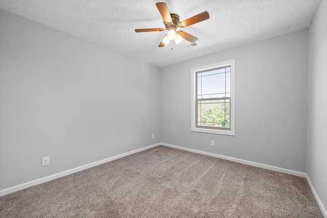 carpeted spare room with a textured ceiling and ceiling fan