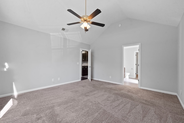 unfurnished bedroom with ensuite bathroom, vaulted ceiling, carpet floors, and ceiling fan