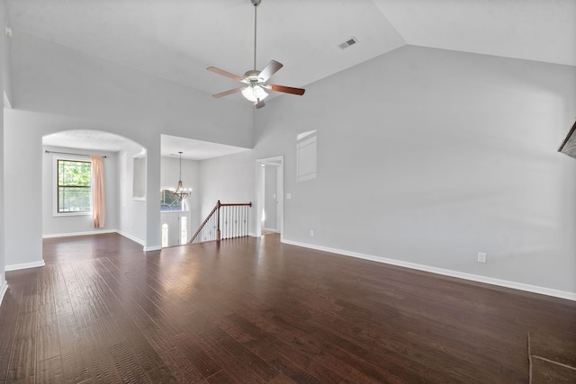 unfurnished living room featuring high vaulted ceiling, ceiling fan with notable chandelier, and dark hardwood / wood-style flooring