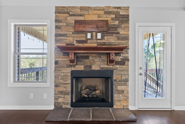 interior details featuring a stone fireplace and hardwood / wood-style floors