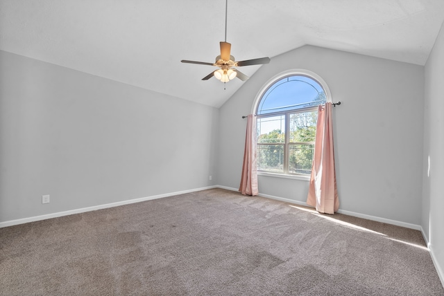 carpeted empty room featuring vaulted ceiling and ceiling fan