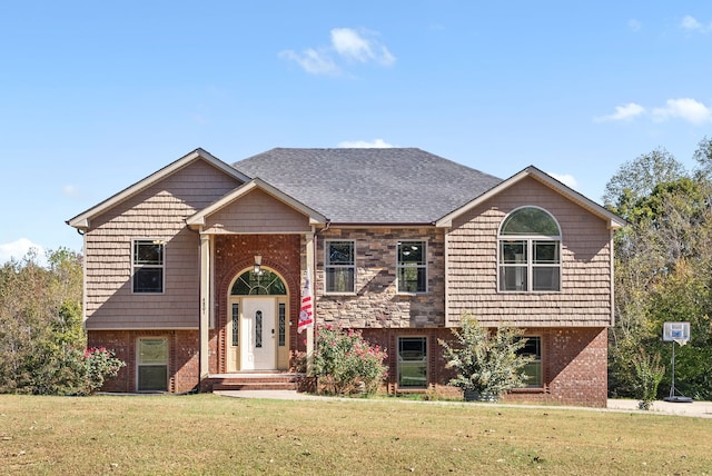 raised ranch featuring a front lawn