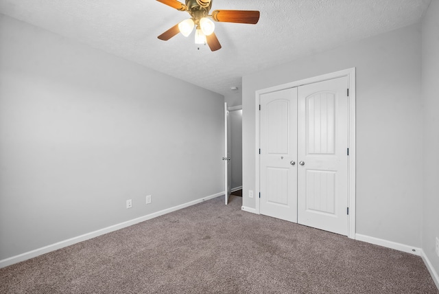 unfurnished bedroom featuring a closet, ceiling fan, carpet, and a textured ceiling