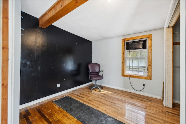 living area with vaulted ceiling with beams and hardwood / wood-style floors