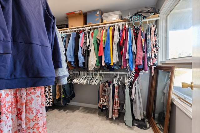 spacious closet featuring light tile patterned floors