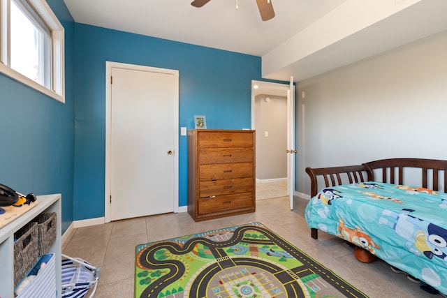 bedroom featuring light tile patterned floors and ceiling fan