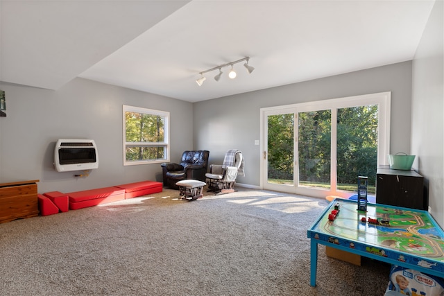 game room featuring carpet flooring, track lighting, and heating unit