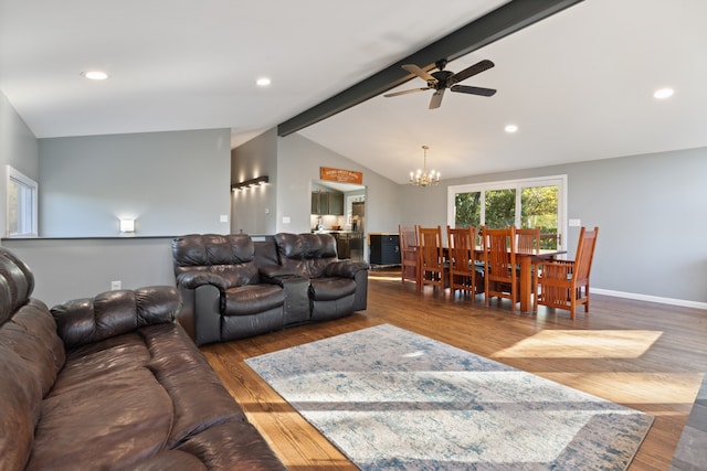 living room with lofted ceiling with beams, dark wood-type flooring, and ceiling fan with notable chandelier