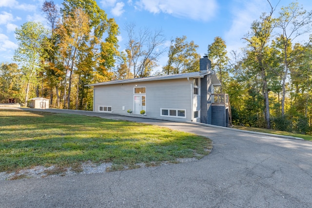 view of home's exterior featuring a yard and a shed