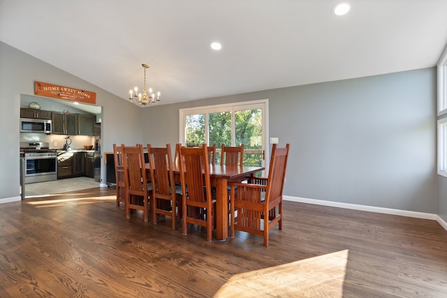 dining area with an inviting chandelier, dark wood-type flooring, and vaulted ceiling