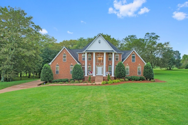 neoclassical home with a front yard and a porch