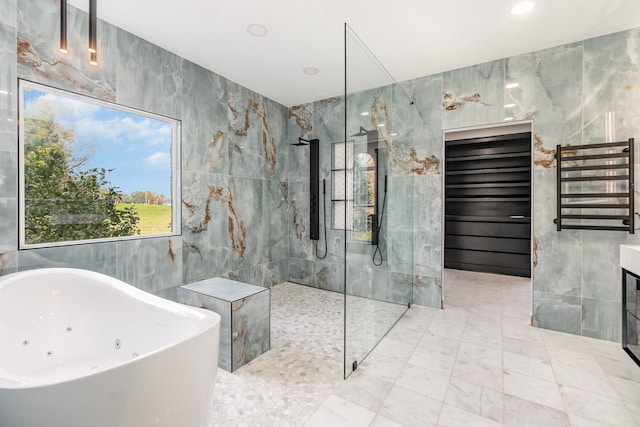 bathroom featuring plus walk in shower and tile walls