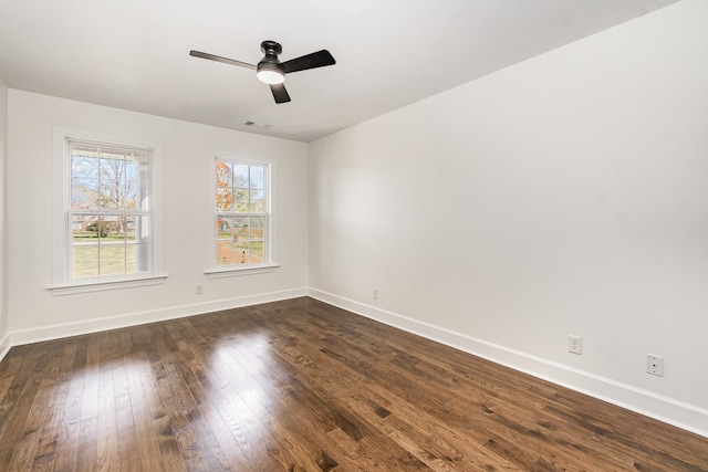 empty room featuring ceiling fan and dark hardwood / wood-style flooring