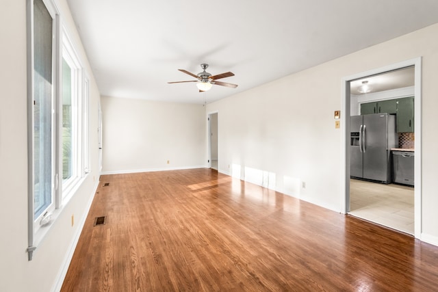 spare room featuring ceiling fan and light hardwood / wood-style floors