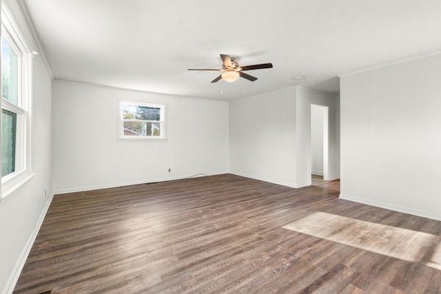 empty room with ceiling fan, dark hardwood / wood-style floors, and ornamental molding