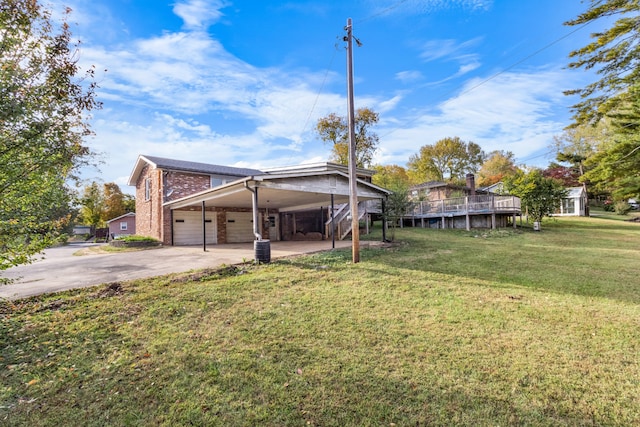 exterior space with a carport and a lawn